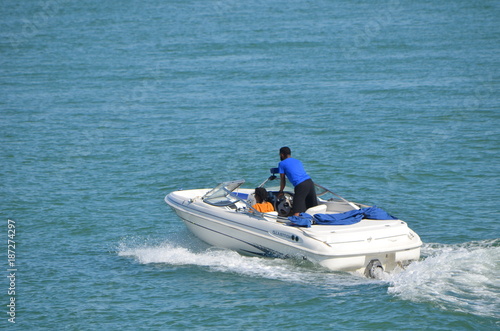 Couple enjoying an afternoon cruise in a motor boat on the florida intra-coastal waterway near Miami Beach.