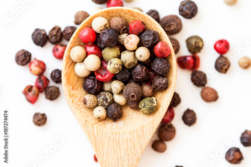 Close up mixed type of the peppercorns in wooden spoon   top view or overhead shot
