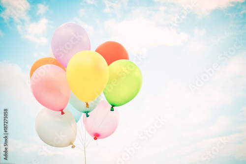 Vintage multicolor balloons with done with a retro instagram filter effect on blue sky. Ideas for the background of love in summer and valentine  wedding honeymoon concept.
