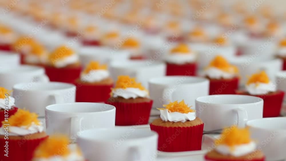 Cupcake in packaging or delivery box, vanilla cupcakes pink, white cream with coffee cup in row on desk for serve in meeting hall, selective focus, close up Cupcake in packaging or delivery box, vanilla cupcakes pink, white cream with coffee cup in row on desk for serve in meeting hall, selective focus, close up