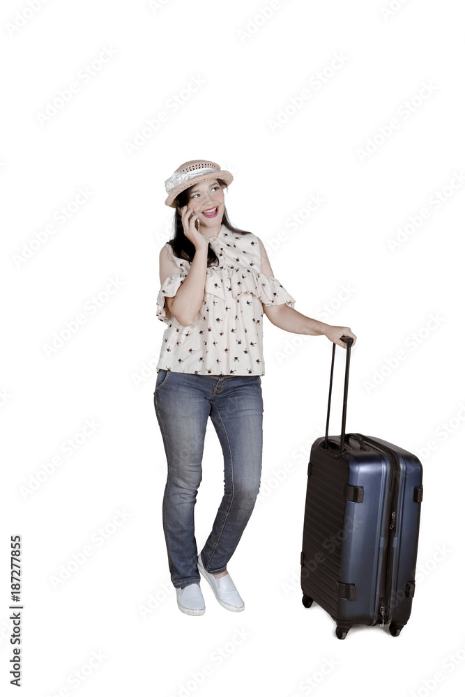 Caucasian woman with mobile phone and luggage