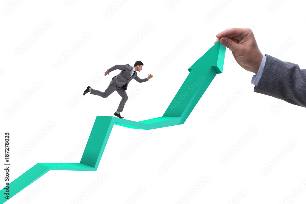 Businessman supporting growtn in economy on chart graph Businessman supporting growtn in economy on chart graph