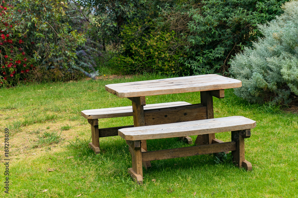 Wooden picnic table and two benches outdoors Wooden picnic table and two benches outdoors
