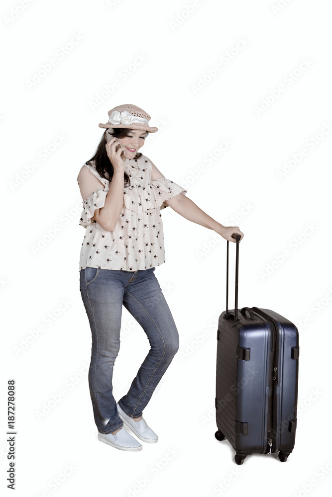 Caucasian tourist with smartphone and suitcase Caucasian tourist with smartphone and suitcase