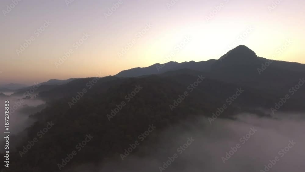 aerial shot : cloud surfing in mountain range sunrise background aerial shot : cloud surfing in mountain range sunrise background