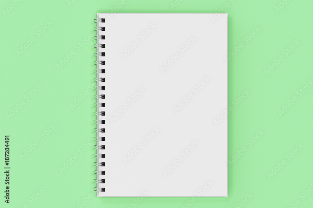 Opend notebook spiral bound on green background Opend notebook spiral bound on green background