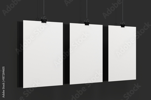 Three blank white posters with binder clip mockup on black background