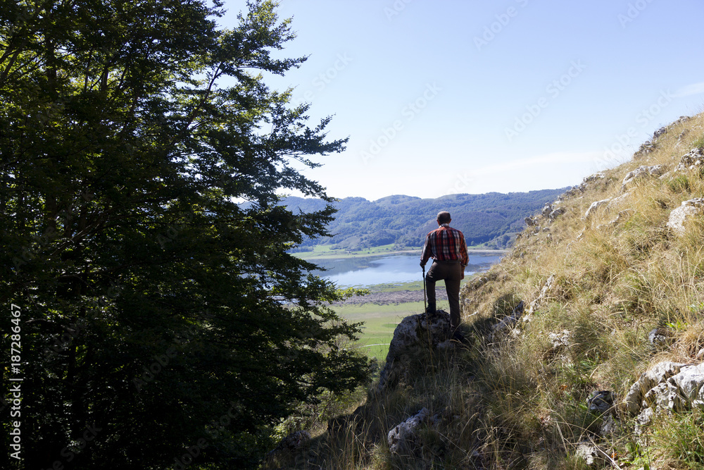 hiker on mountain peak and lake matese