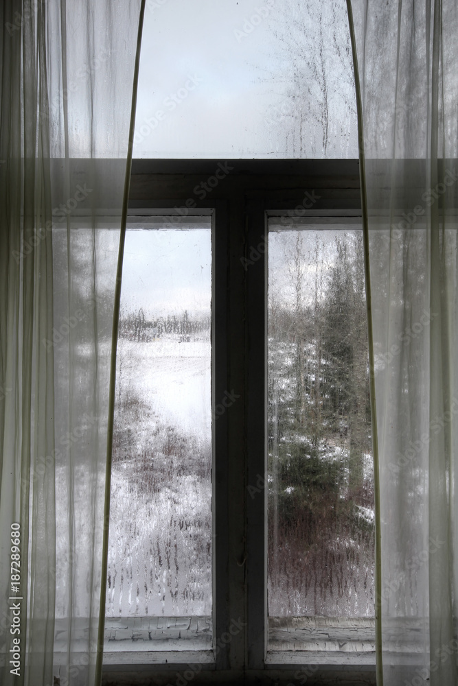 Window of old abandoned farm house in Southern Finland. Cold winter day. Window of old abandoned farm house in Southern Finland. Cold winter day.