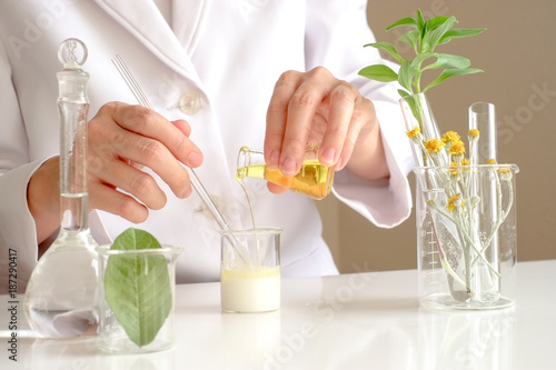 the scientist,dermatologist testing the organic natural product in the laboratory.research and development beauty skincare concept.blank package,bottle,container .cream,serum.