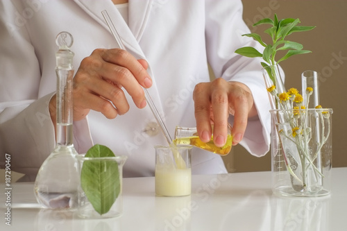 the scientist,dermatologist testing the organic natural product in the laboratory.research and development beauty skincare concept.blank package,bottle,container .cream,serum.