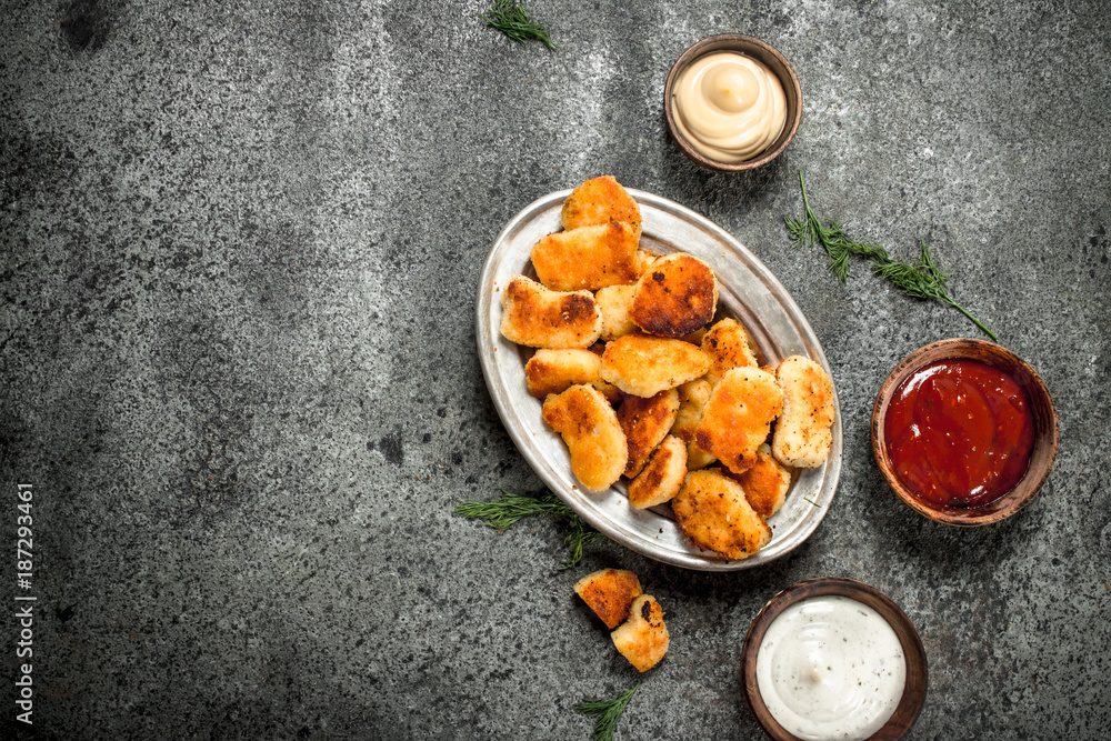 Fototapeta premium Chicken nuggets with various sauces.