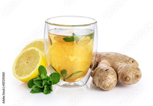 Hot tea with mint, lemon and ginger in a glass with double walls isolated on white background.