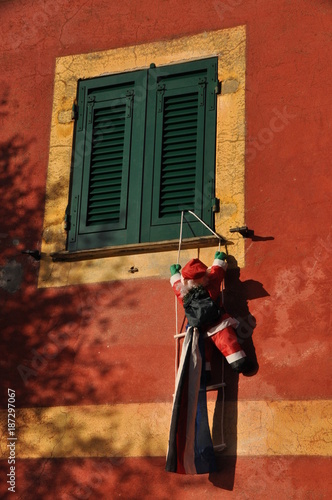 Santa Claus with a closed shutter in the small village of Mortola near San Rocco, Camogli, Liguria, Genoa Province, Italy photo