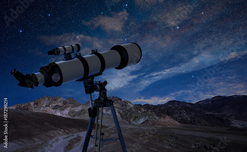 telescope on a tripod pointing at the night sky