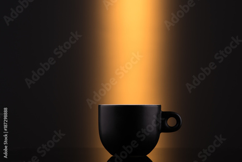 Black cup on an orange background