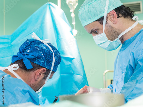 Real surgery team in the operating room. Photos from a live session of breast augmentation surgery.