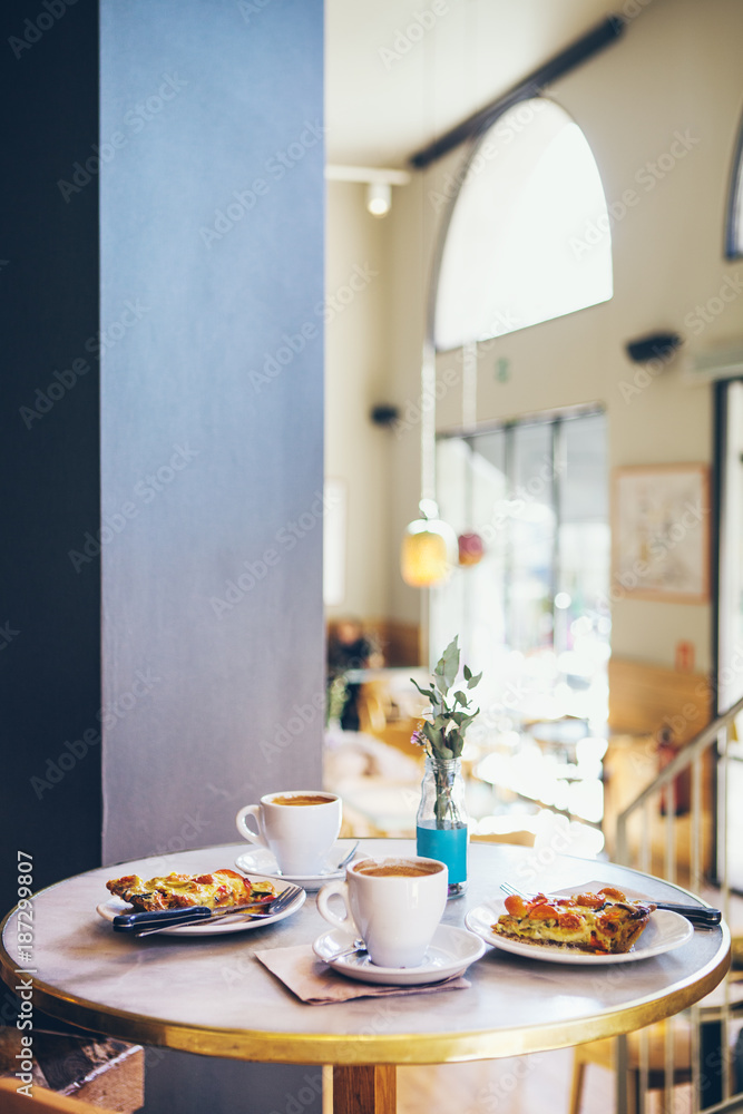 Breakfast for two persons in a cafe, warm quiche and coffee, no people. Breakfast for two persons in a cafe, warm quiche and coffee, no people.