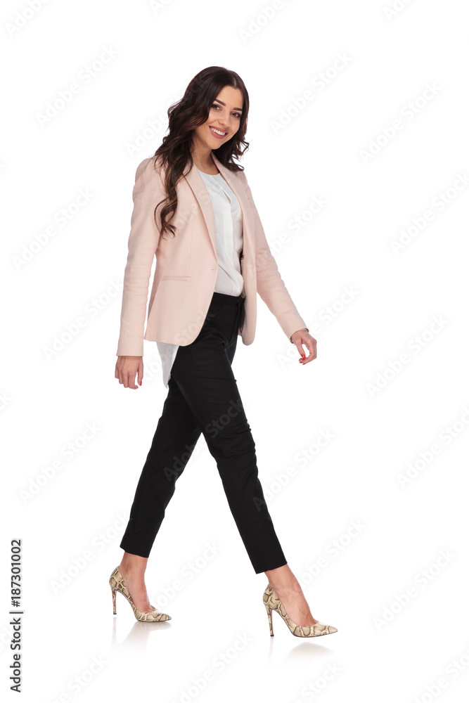 side view of a happy business woman walking side view of a happy business woman walking
