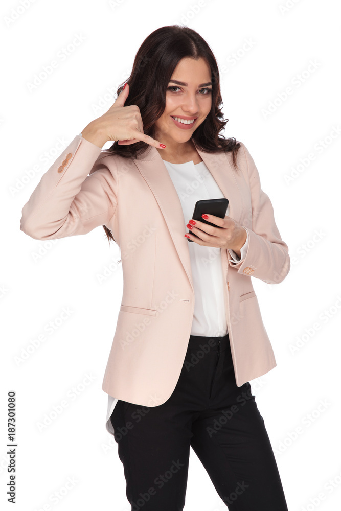 businesswoman making the call me sign while texting on phone businesswoman making the call me sign while texting on phone