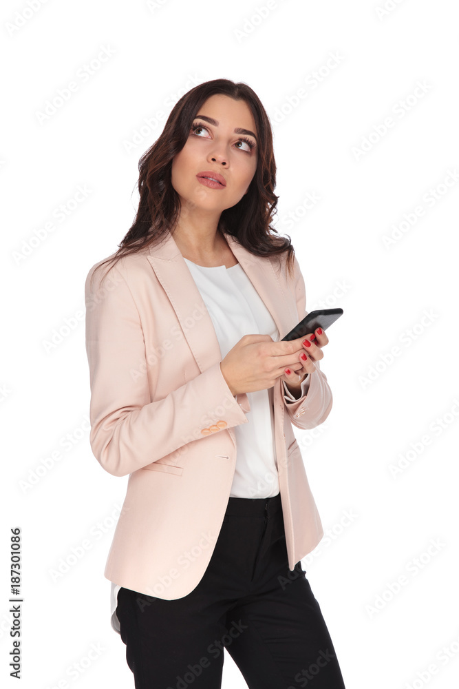 pensive young business woman texting and looks up to side pensive young business woman texting and looks up to side