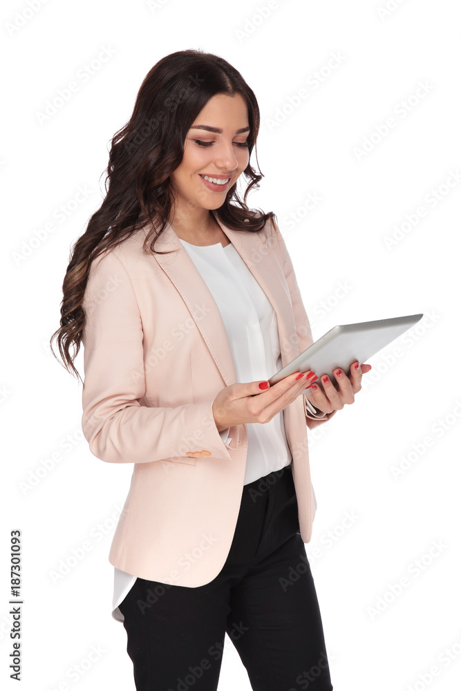 happy young woman holding a tablet and smiles happy young woman holding a tablet and smiles