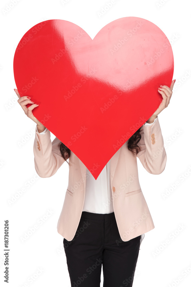 woman covering her face with a big red heart shape woman covering her face with a big red heart shape