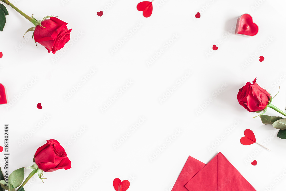 Valentine's Day. Frame made of rose flowers, gifts, candles, confetti on white background. Valentines day background. Flat lay, top view, copy space - obrazy, fototapety, plakaty 