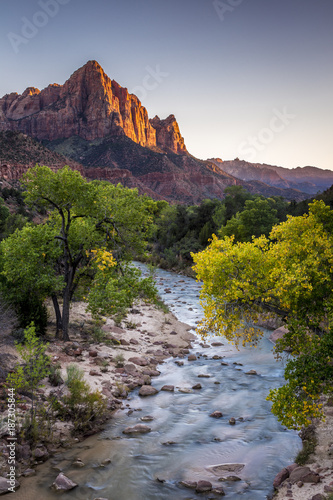 Sunset at Zion Nationalpark, Utah with the flowing virgin river leading to the watchman in the background