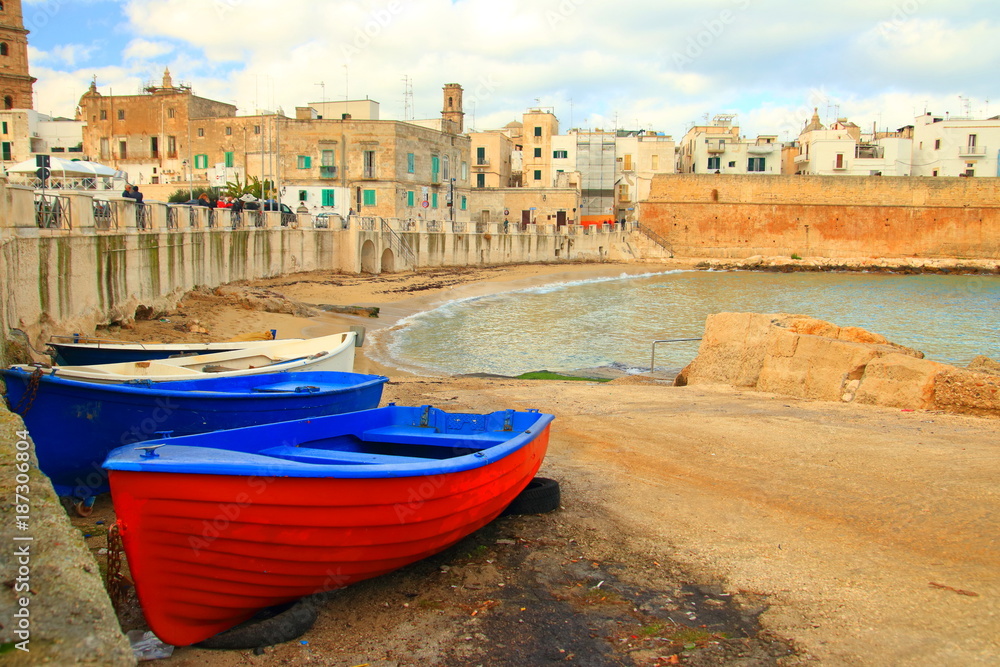 Colorful boats on sandy beach in Monopoli, Puglia, Italy
