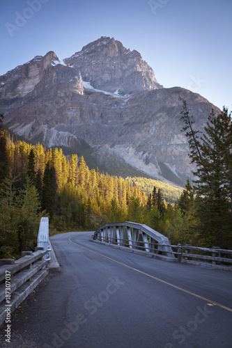 A street leading into a bridge with a beautiful view of the Canadian Rocky-Mountains