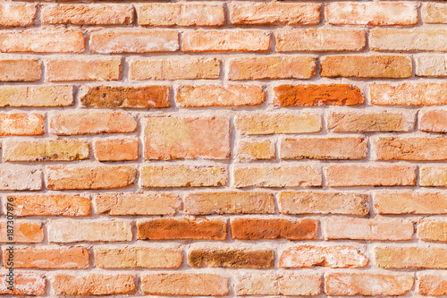 Wallpaper of a red antique brick wall with colored bricks