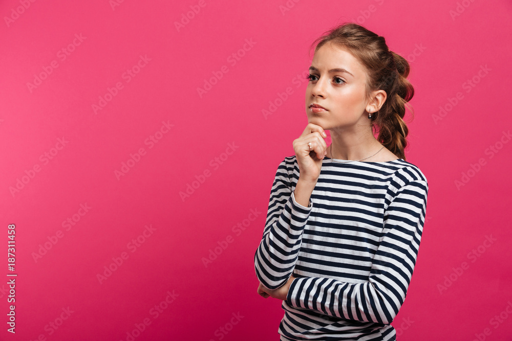 Fototapeta premium Thoughtful teenage girl standing isolated