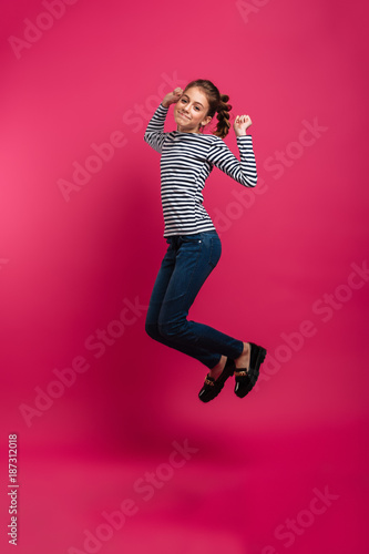 Cheerful teenage girl jumping