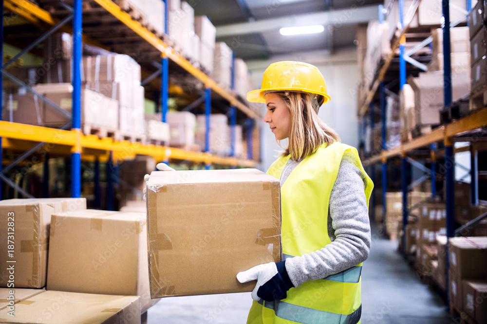 Female warehouse worker loading boxes. Female warehouse worker loading boxes.