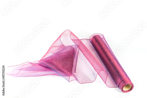 Roll with colored transparent fabric on white background