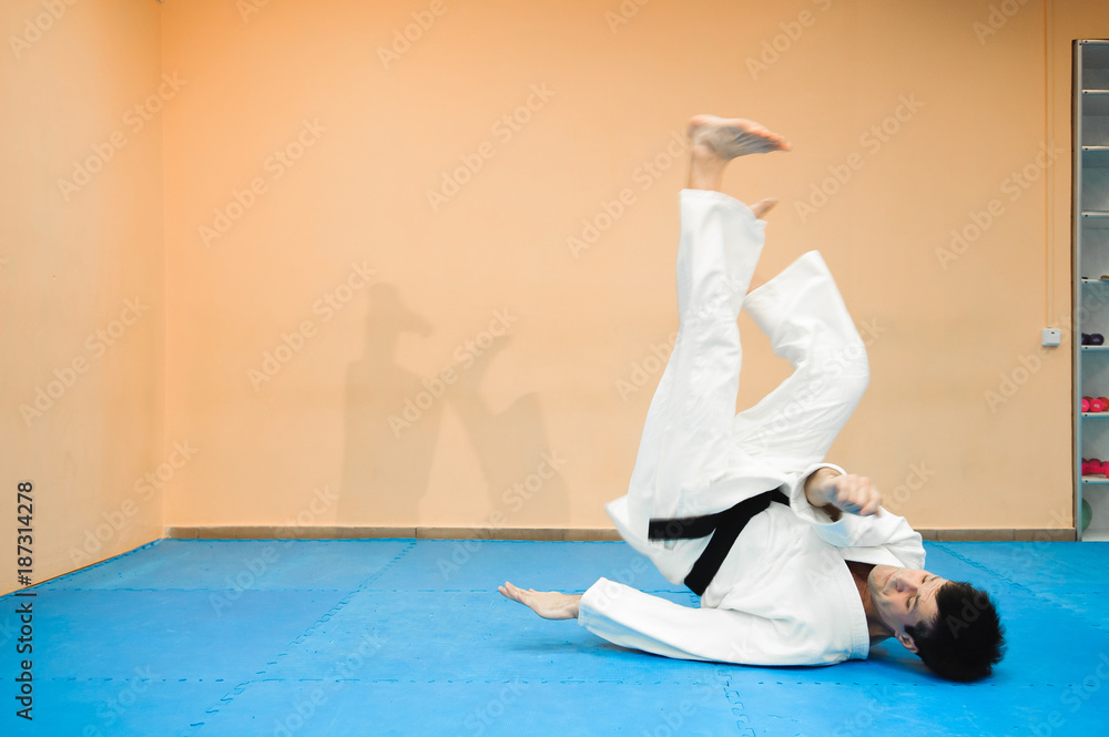 Naklejka premium Man fighting at Aikido training in martial arts school