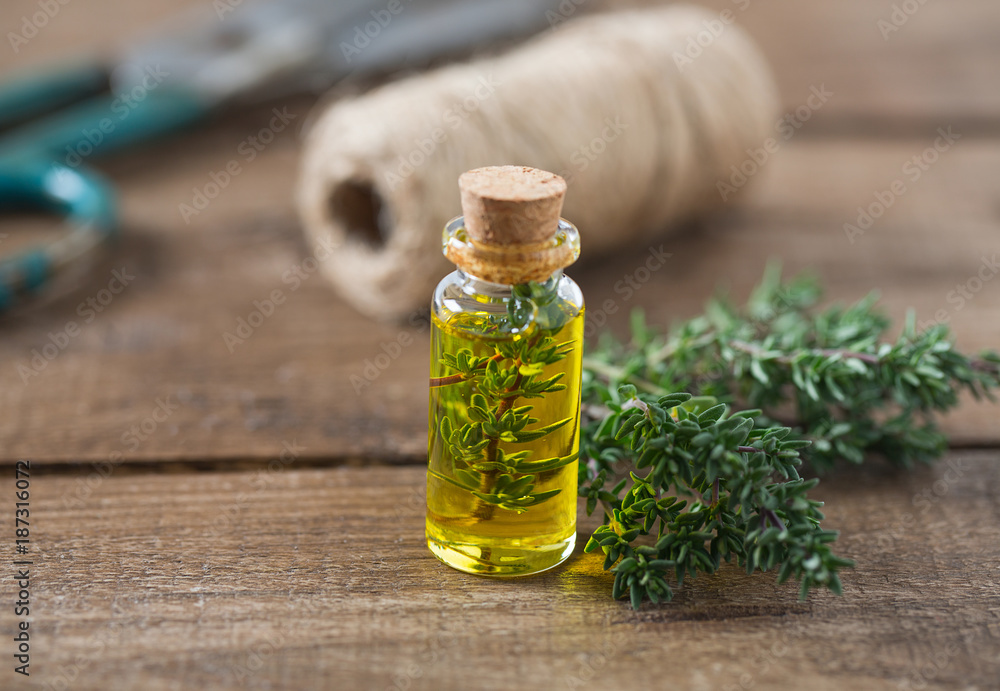 thyme oil on wooden surface thyme oil on wooden surface