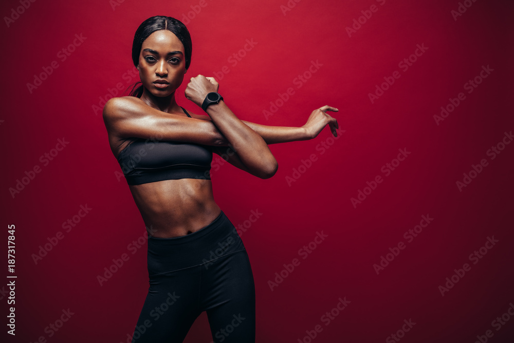 Strong woman stretching her arms Stock Photo