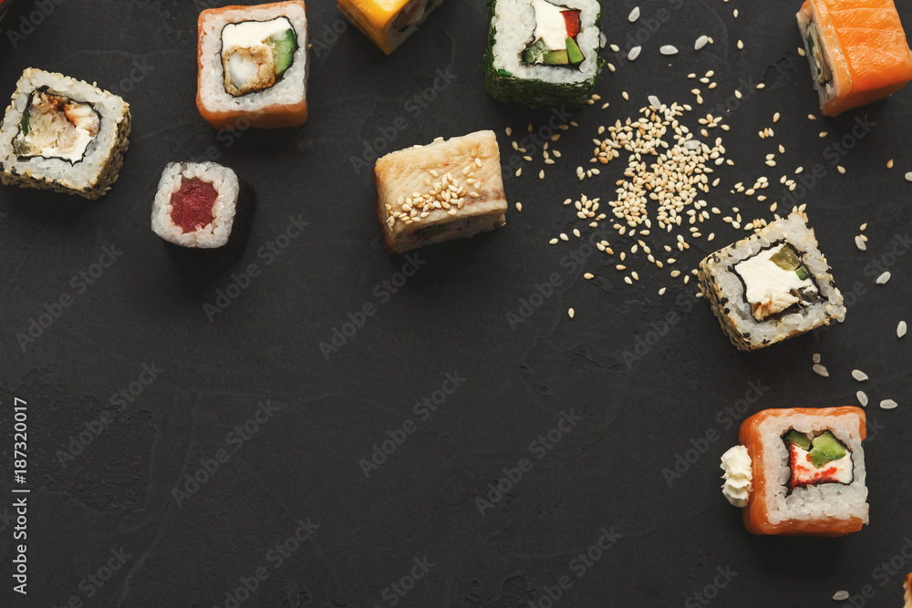 Sushi and rolls background, frame on black, top view. Sushi and rolls background, frame on black, top view.