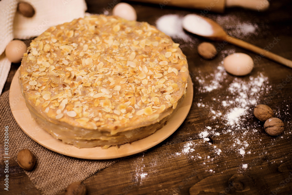 Homemade cake with cream on a wooden surface Homemade cake with cream on a wooden surface
