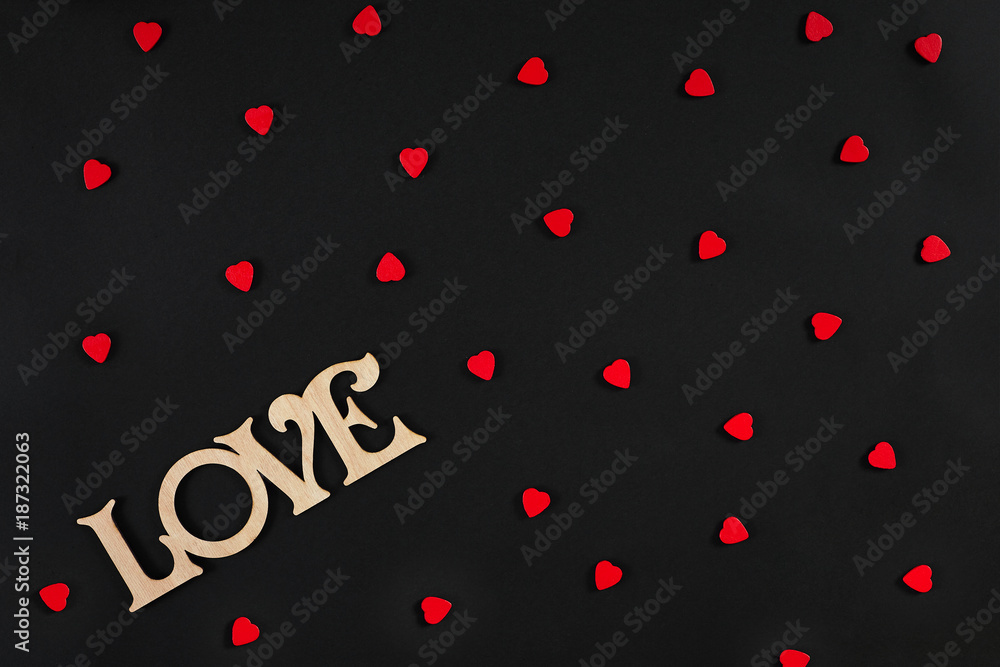 Valentines day background. Red hearts on the black desk Valentines day background. Red hearts on the black desk