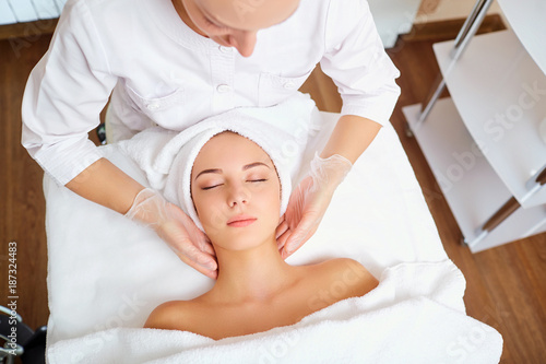 Beautiful woman at a facial massage at a spa salon.