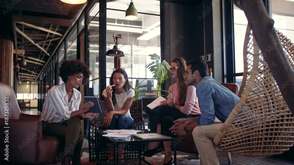 Corporate business team discussing new ideas over digital tablet. Creative business team meeting in modern office.