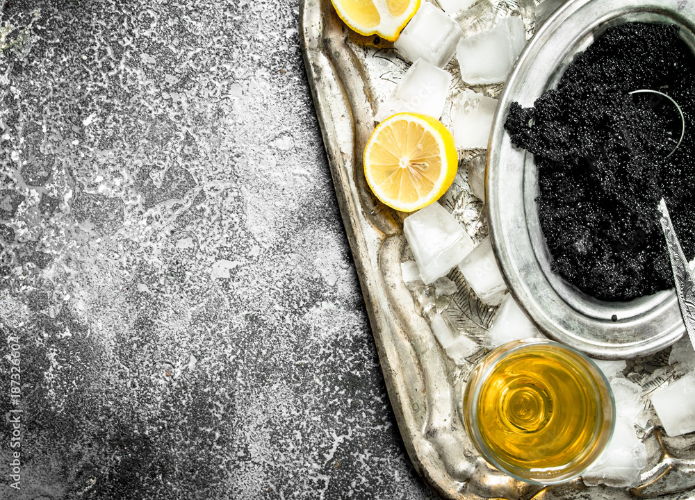 Black caviar with white wine and slices of lemon. Black caviar with white wine and slices of lemon.
