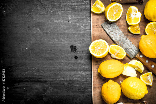 Slicing fresh lemons on the board. photo