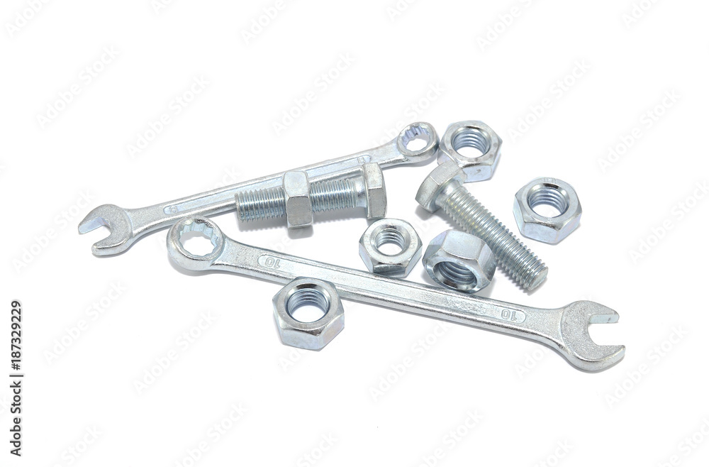 Bolt, nut and wrench on white background close-up 
