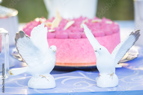 wedding figures and cake on the table