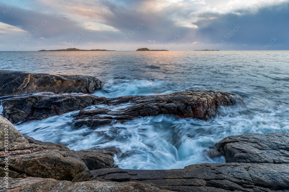 Waves at the shore in Helleviga recreation area, blue hour in South Norway Waves at the shore in Helleviga recreation area, blue hour in South Norway