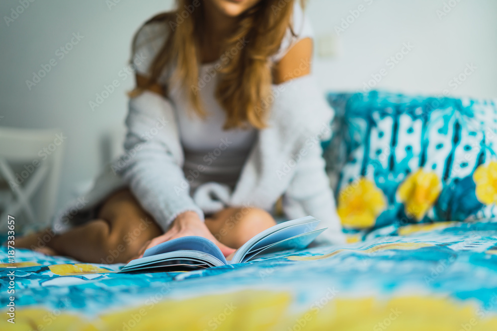 Pretty woman reading book on bed Pretty woman reading book on bed